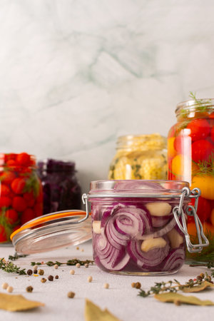 Fresh red onion fermenting in a jar with spices, creating a healthy probiotic-rich food, fresh...