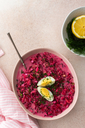 Summer cold beetroot soup made from beets, radishes, cucumbers, potatoes and herbs, garnished with egg, a refreshing summer lunchの写真素材