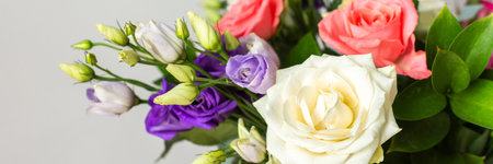 This seasonal bouquet of roses, eucalyptus, and eustoma in soft pink, white, and purple tones makes an ideal gift for anniversaries, birthdays, bannerの写真素材