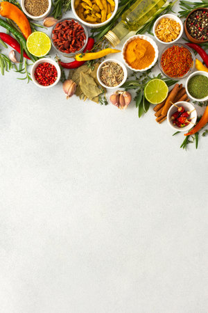 Colorful herbs and spices scattered across a gray surface, ideal for creating authentic and flavorful dishes, top view ,copy spaceの写真素材
