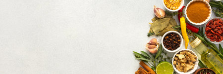 A wide selection of cooking spices and herbs on a gray background, perfect for adding depth to any dish, top view, copy space, bannerの写真素材