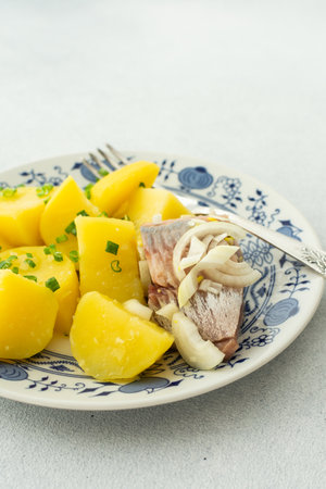 Delicious hearty fish dinners, boiled potatoes with pickled herringの写真素材