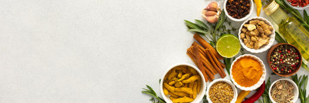A wide selection of cooking spices and herbs on a gray background, perfect for adding depth to any dish, top view, copy space, bannerの写真素材
