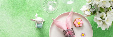 A beautifully arranged table setting for Easter features a pink napkin wrapped around an egg,...