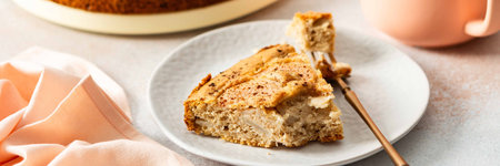 A slice of pear pie sits on a white plate with a fork. A warm coffee cup is next to it. Fresh pears...