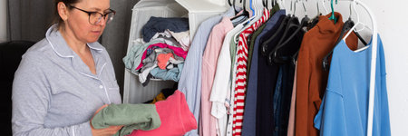 A woman is selecting her home clothes in the morning. This scene takes place in a city, showing...