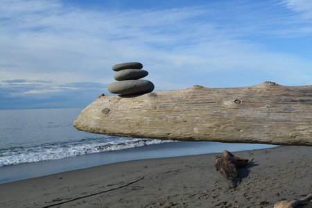 Cairn on driftwoodの写真素材