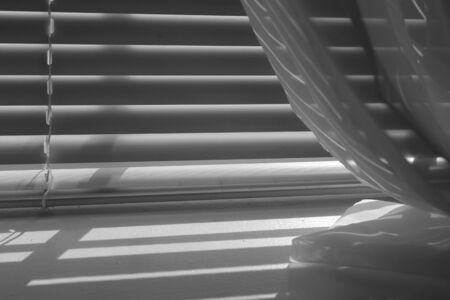 Black and white shot of window sill and shadowsの写真素材
