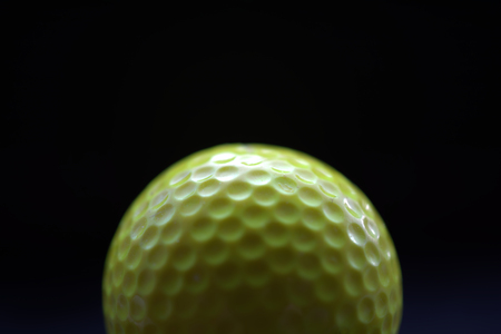 23 of a yellow gold ball with dark backgroundの写真素材