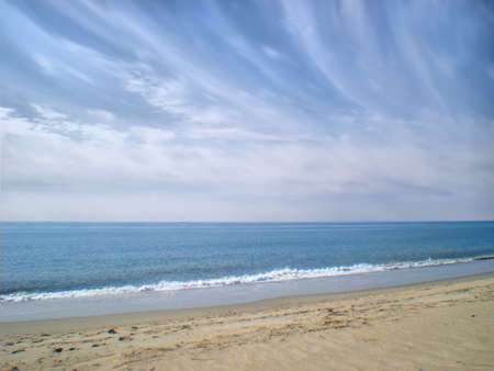 Beach, water and sky with cloudsの写真素材