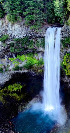 Waterfall into blue poolの写真素材