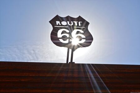 Route 66 sign with the sun shining throught the signの写真素材