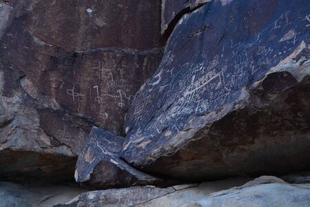 Petroglyphs in the shadows of rocksの写真素材