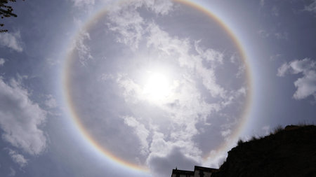 Sun halo white some rock and tree branches on the sunny dayの写真素材
