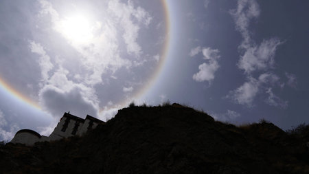 Sun halo white some rock and tree branches on the sunny dayの写真素材