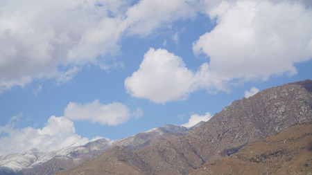 Mountain peak with some clouds and clear blue skyの写真素材
