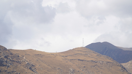 Mountain peak with some clouds and clear blue skyの写真素材