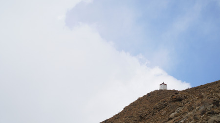 Mountain peak with some clouds and clear blue skyの写真素材