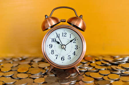 alarm clock and coinsの写真素材