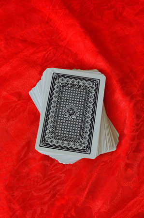 cards on red felt poker table backgroundのeditorial素材