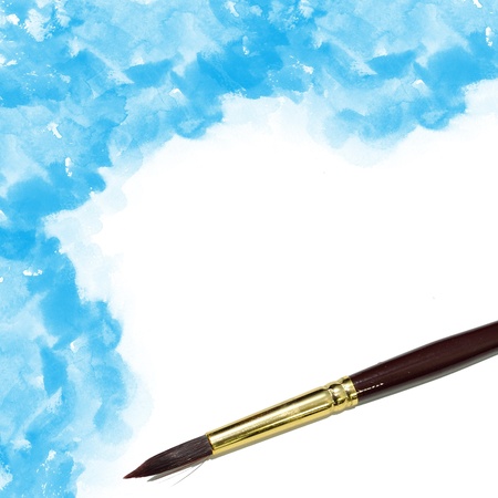 background with artists brush and blue watercolor paintedの写真素材