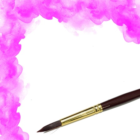 background with artists brush and pink watercolor paintedの写真素材