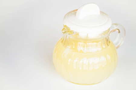 Fresh lime juice in glass jar on white backgroundの写真素材