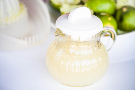 Fresh hand squashed lime juice in glass jarの写真素材
