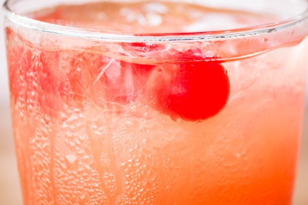 Red cherry on iced mix fruits juice sodaの写真素材