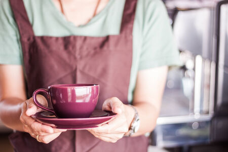 Shop owner serving freshly brewed coffee, stock photoの写真素材