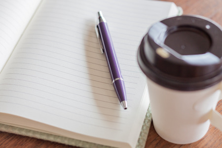 Pen and notebook with coffee cup, stock photoの写真素材