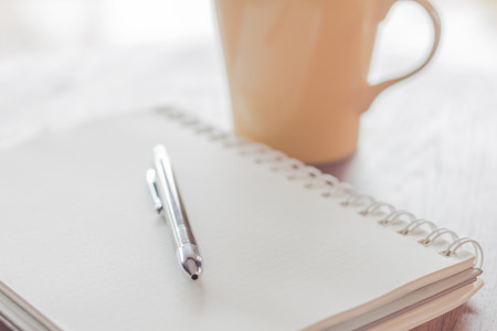 Notebook with pen on wooden table, stock photoの写真素材