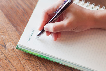 Writing important note on spiral notebook