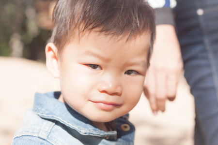 Little asian boy looking at camera , stock photoの写真素材