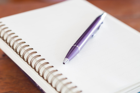 Blank notebook with pen on wooden table, stock photoの写真素材