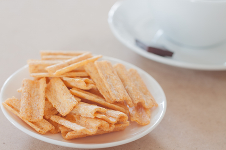 Snack on white plate with coffee cup, stock photoの写真素材
