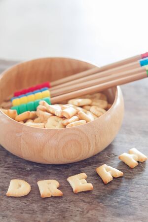 Dream alphabet biscuit on wooden table, stock photoの写真素材