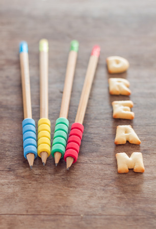 Dream alphabet biscuit on wooden table, stock photoの写真素材