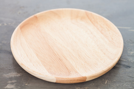 Wooden plate on gray background, stock photoの写真素材