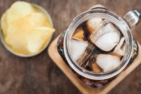 Iced cola with potato chips, stock photo