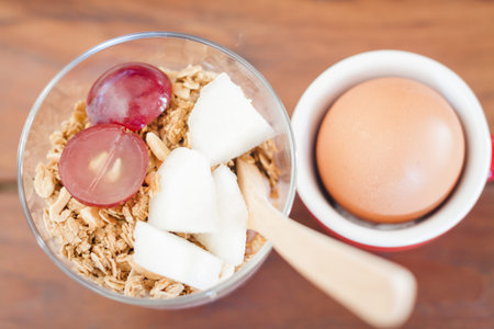 Granola with fruits and boiled egg, stock photo