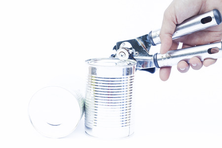 Close-up tin can with hand isolated on white background, stock photoの写真素材