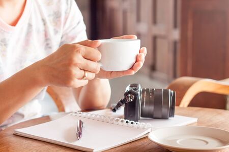 Woman with cup of coffee in coffee shop, stock photoの写真素材