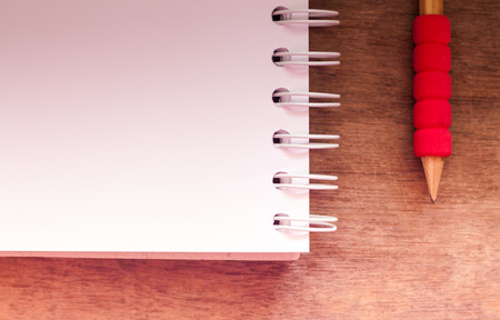 Work station with notebook and pencil with vintage filter, stock photoの写真素材