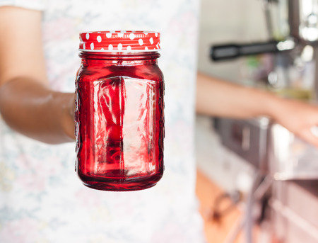 Woman's hand holding red glass, stock photoの写真素材