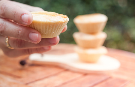 Woman's hand holding mini pies, stock photoの写真素材