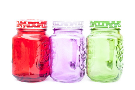 Colourful mason glasses on white background, stock photo