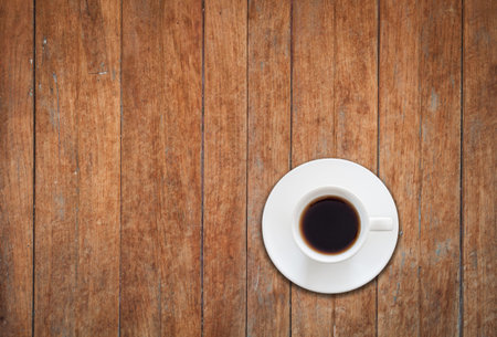 Top view of white coffee cup on wooden background, stock photoの写真素材