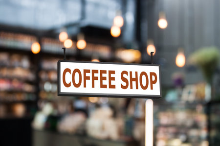 Coffee shop signboard with coffee shop blurred background with bokehの写真素材