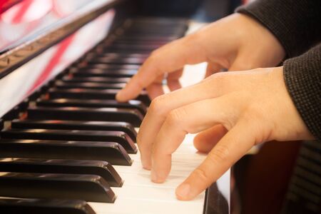 Woman playing on piano keyboard, stock photoの写真素材